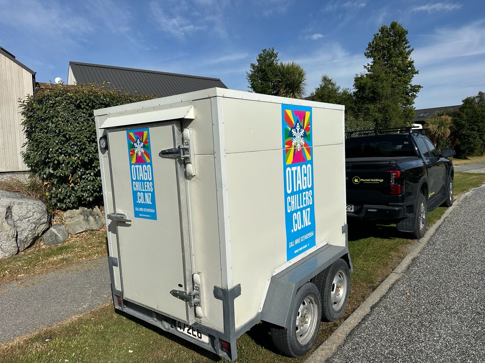 Large tandem axle catering chiller trailer parked on a driveway