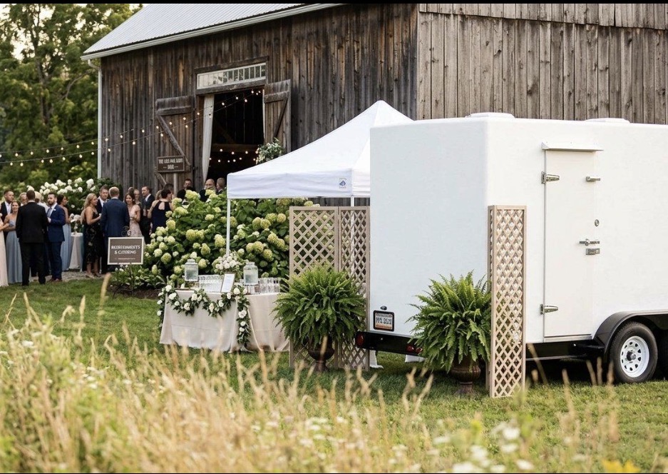 Chiller trailer set up beside a catering marquee at an outdoor event